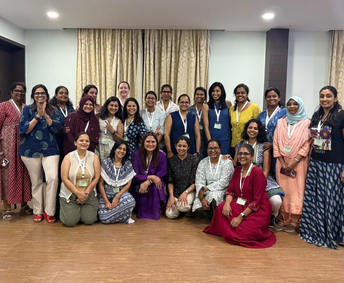 Ayisha Chandni with a large group of professionals at a retreat