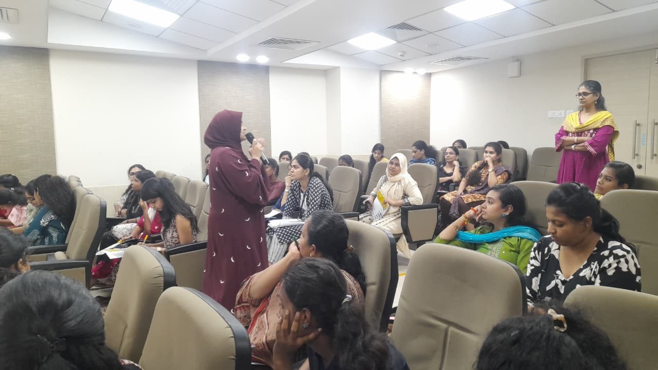 Ayisha Chandni leading a training session for a full audience